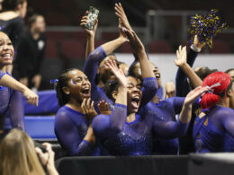 Members of the Fisk University team cheer during a Super 16 gymnastics meet on Jan. 6, in Las Vegas. The Fisk women's gymnastics team became the first historically Black college or university to compete at the NCAA level.